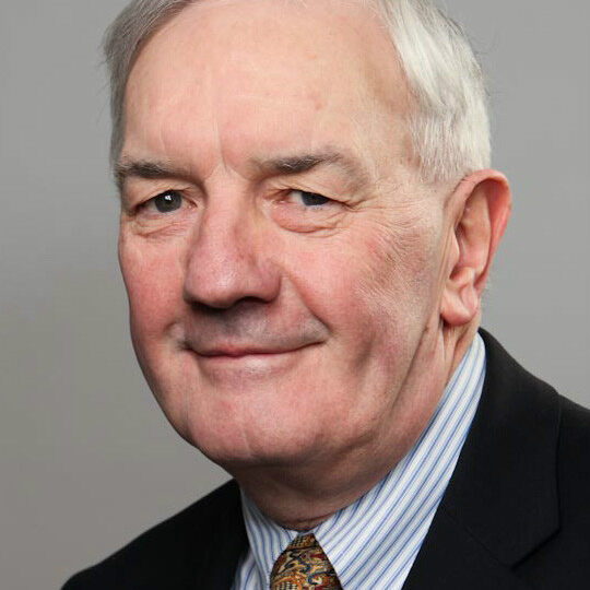 Elderly man in suit and tie.