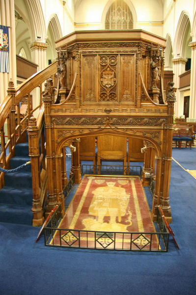 Ornate wooden pulpit inside a church.