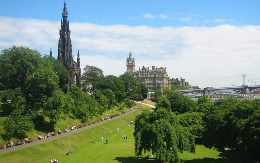 Edinburgh skyline with lush green park scenery.